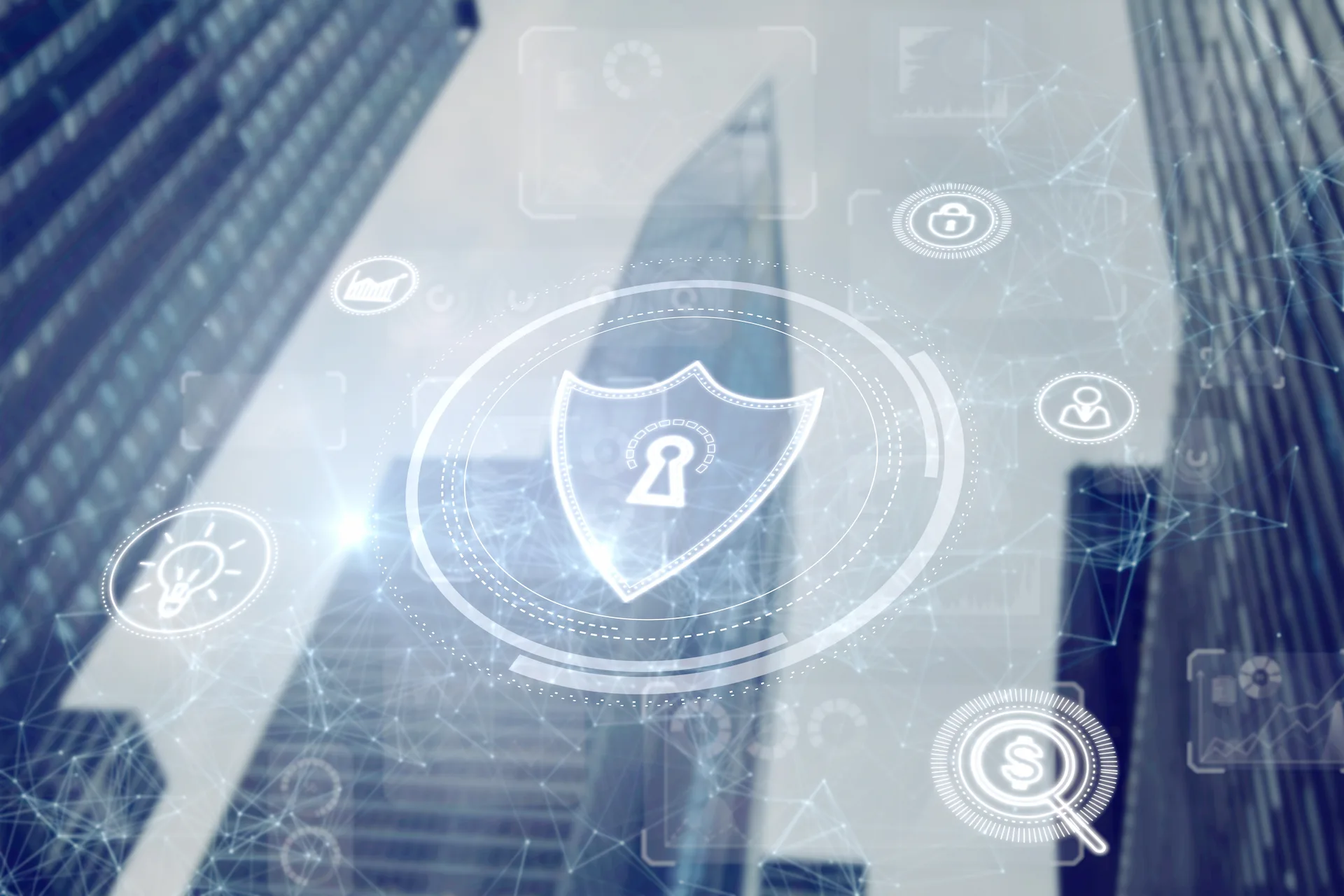 rappresentazione olografica di uno scudo sopra palazzi aziendali a rappresentare Privacy e protezione dei dati aziendali